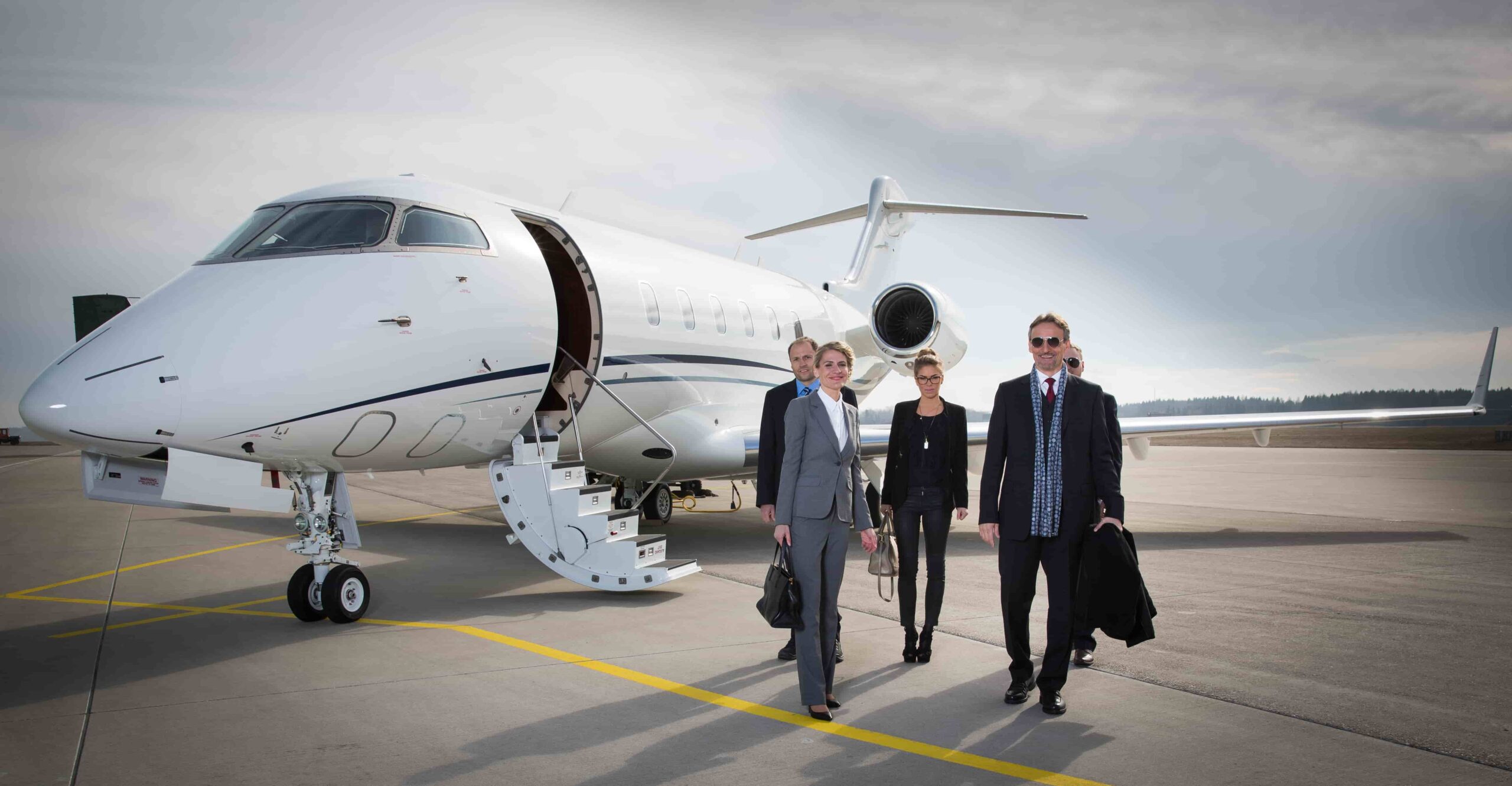 Business executive team outside a jet charter