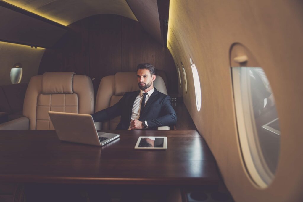 beat jet lag on flight, man in private jet at table